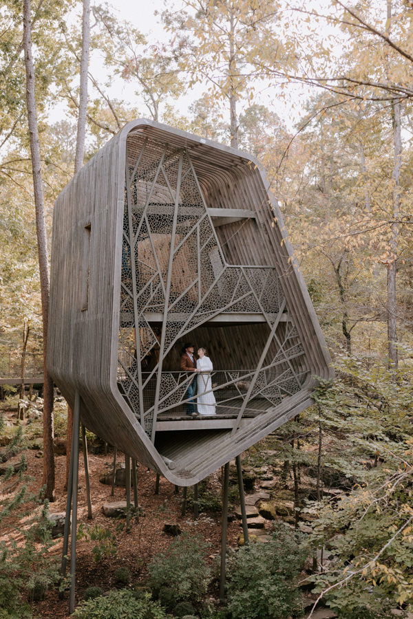 A bride and groom explore the artisan treehouse at Garvan Woodland Gardens in Hot Springs during their Arkansas elopement.