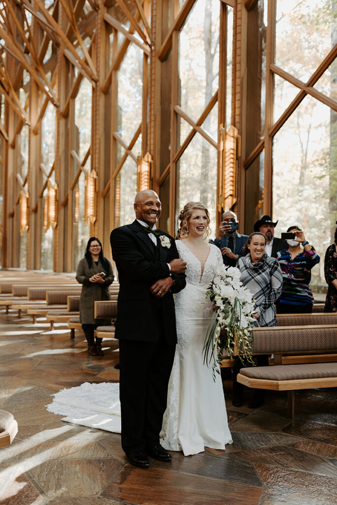 A bride stands in the aisle at Anthony Chapel before being given away to her groom for their ceremony.