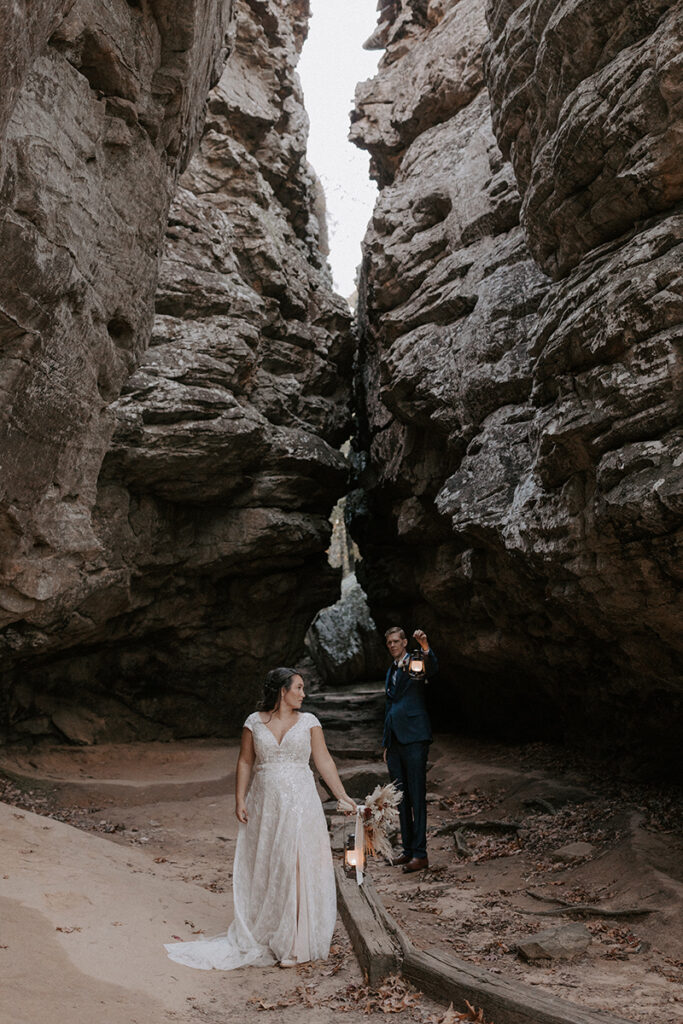 A bride and groom pose for a photo at Bear Cave Trail during their Arkansas elopement at Petit Jean State Park.