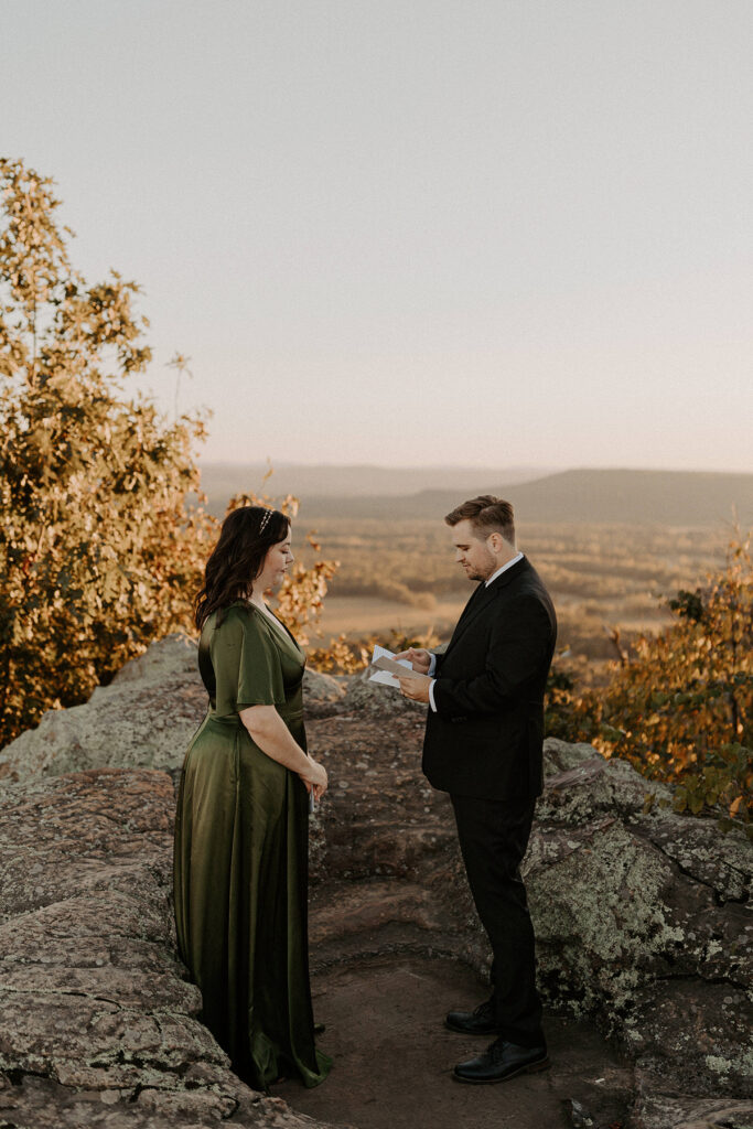 A couple exchange vows during their elopement at Petit Jean State Park in Arkansas.