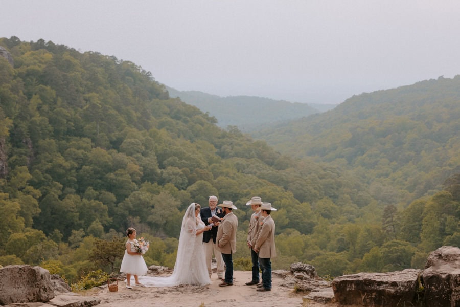 A couple exchanges vows at Mather Lodge overlook at Petit Jean State Park during their Arkansas elopement.