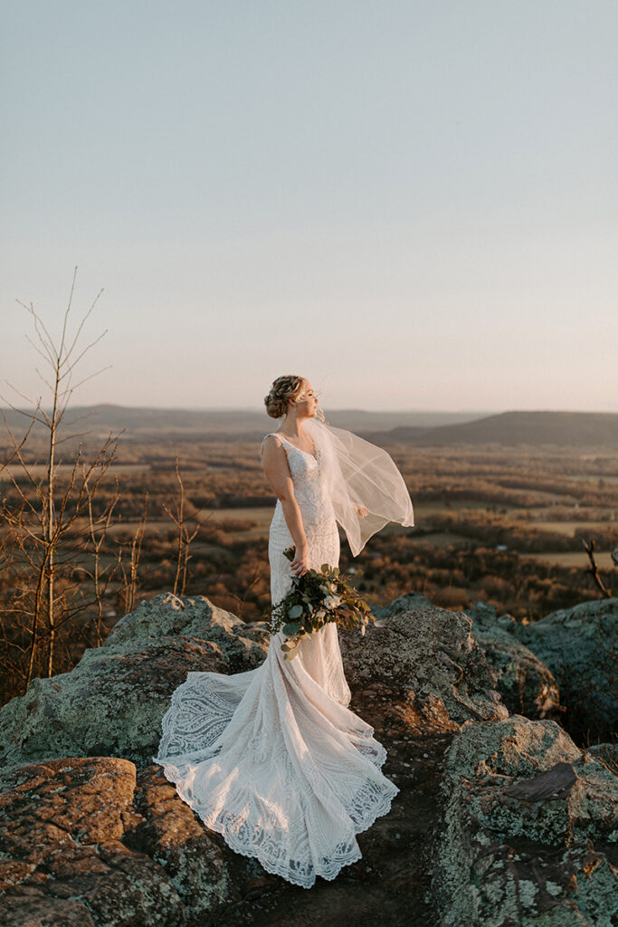 A bride poses for a photo during her bridals at Stouts Point on Petit Jean State Park, a popular elopement destination in Arkansas.