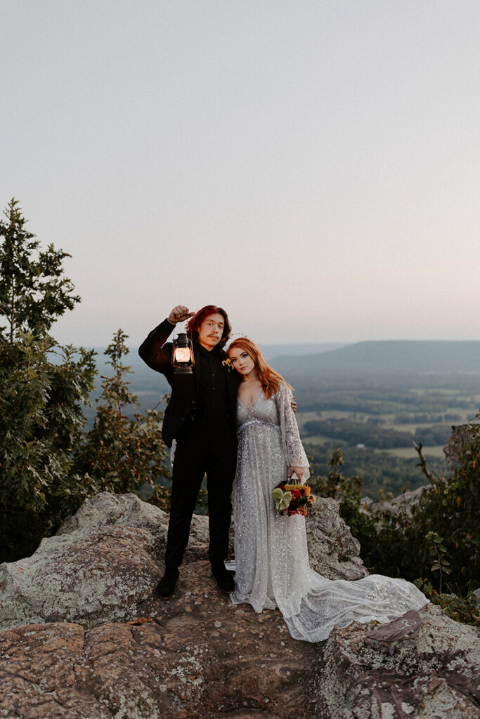 A bride and groom embrace and pose for a photo in their wedding attire during their Arkansas elopement at Petit Jean State Park.