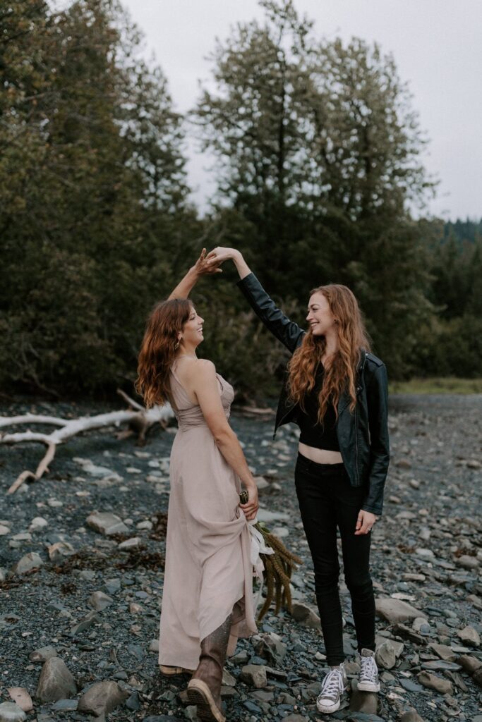 A couple dances on a beach in Seward, Alaska during their Kenai Fjords elopement: Best places to elope in Alaska.