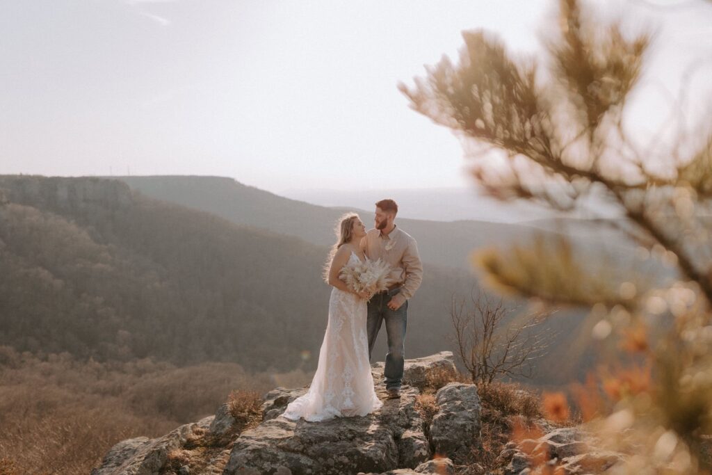 A couple embraces at sunset during their Mount Magazine State Park elopement in Arkansas.