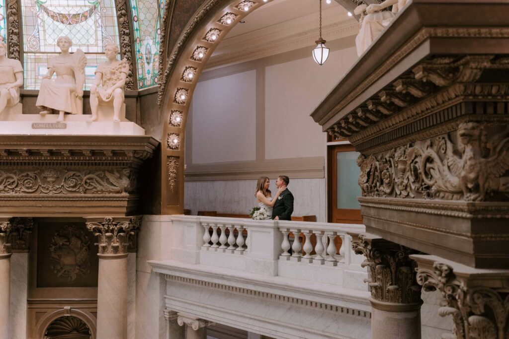 A couple embraces across the balcony upstairs at the Pulaski County Courthouse in Little Rock, Arkansas.