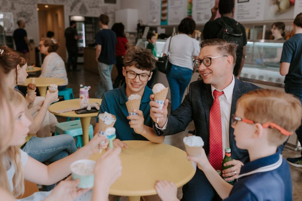 A family of 5 sits at a table at Loblolly Creamery in Little Rock, Arkansas after having just left the Pulaski County Courthouse for the parent's elopement ceremony.
