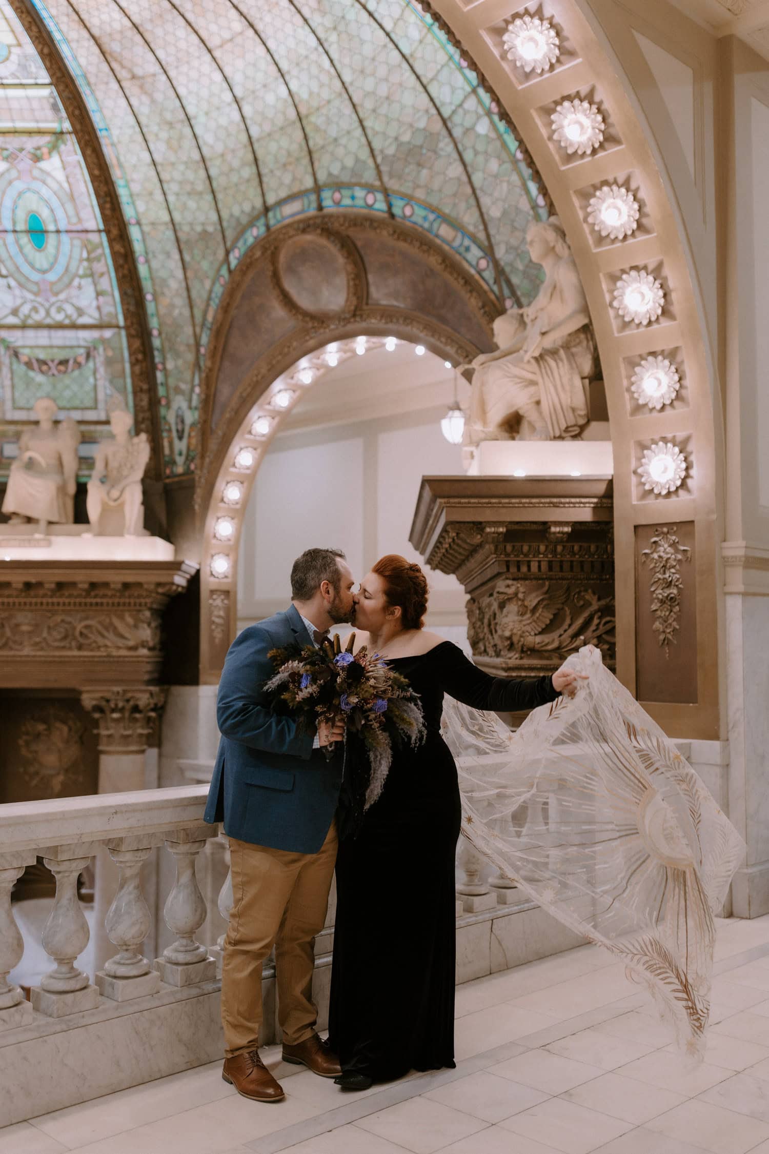 A couple kisses during their elopement ceremony at Pulaski County Courthouse in Little Rock, Arkansas