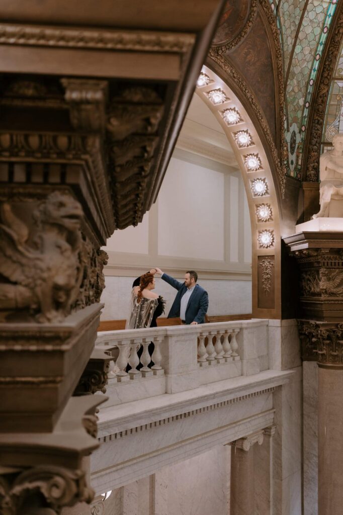 A bride twirls for her husband during their elopement photos at Pulaski County Courthouse in Little Rock, Arkansas.