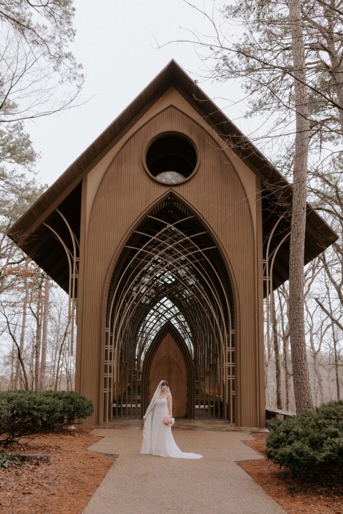 A bride poses for a photo during a winter vow renewal at Cooper Chapel in Arkansas.