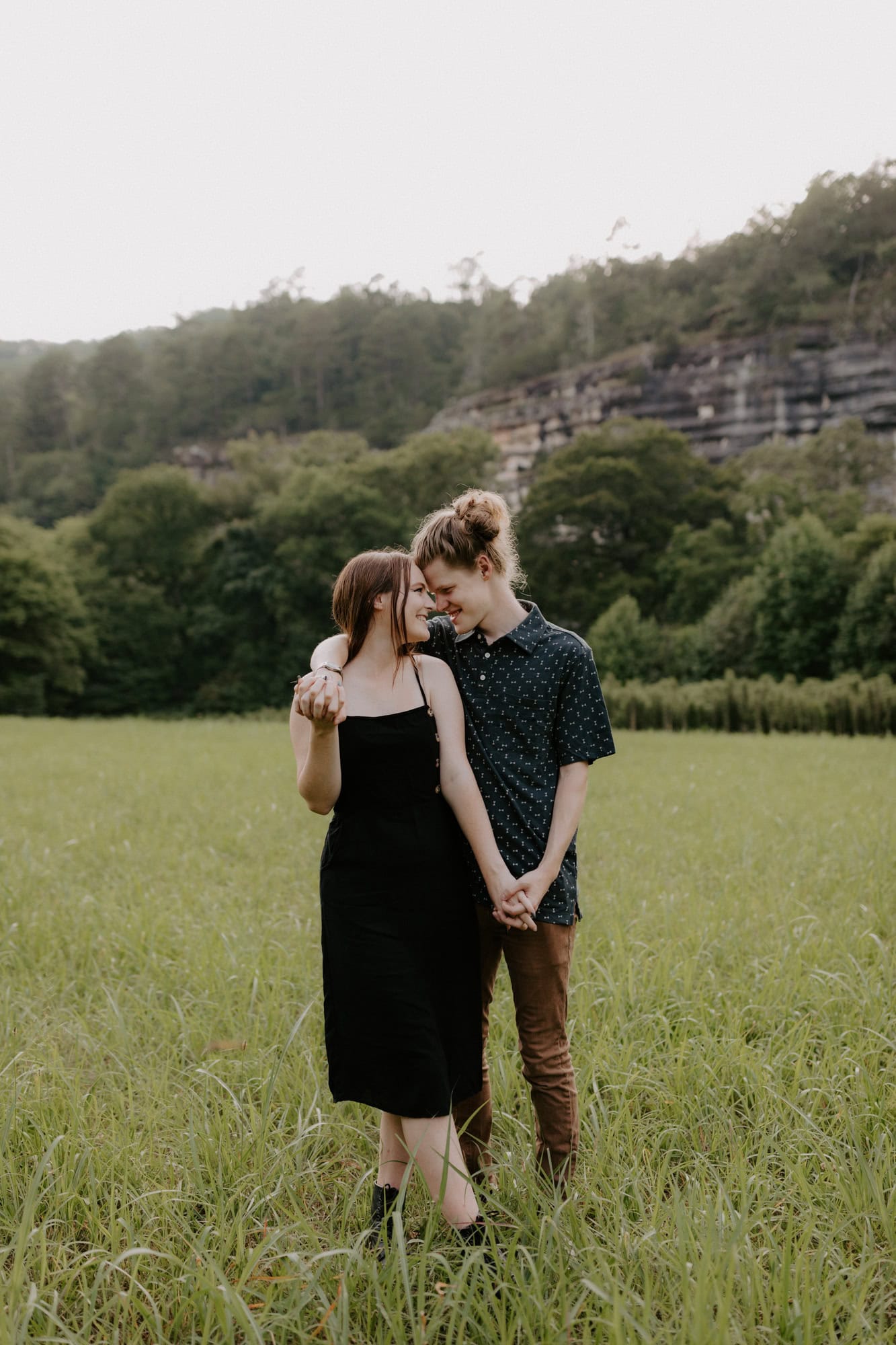A couple poses for a photo at Steel Creek Campground for engagement pictures.