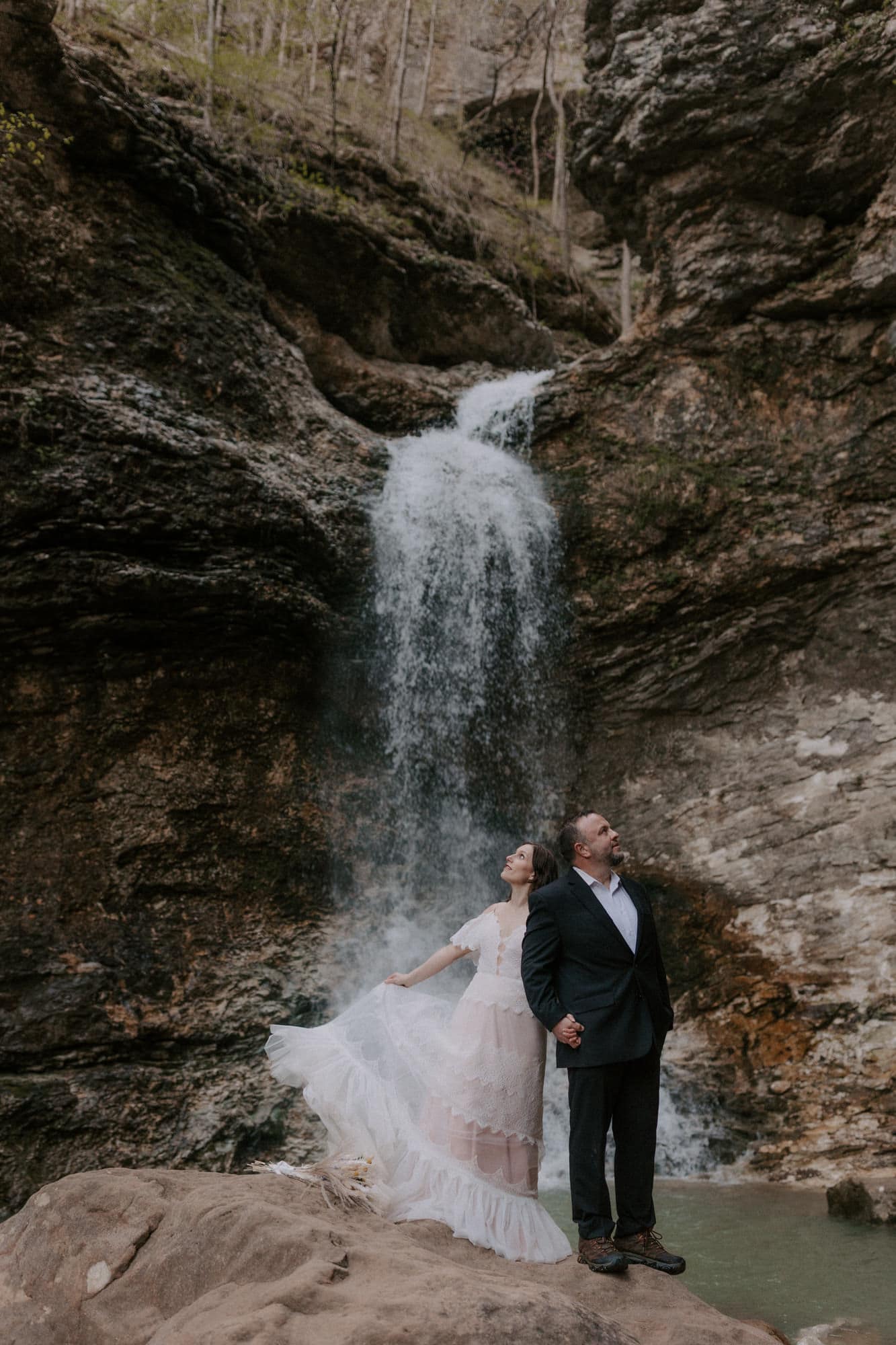 A couple poses for a photo below Lower Eden Falls during their Lost Valley elopement.