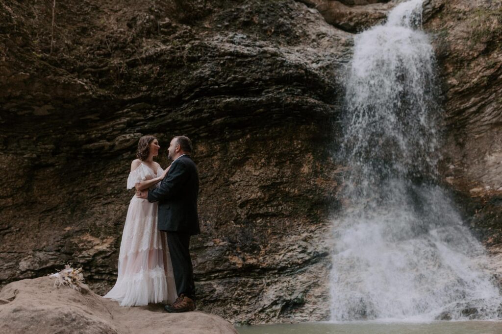A couple embraces below Eden Falls at Lost Valley in Ponca, Arkansas.