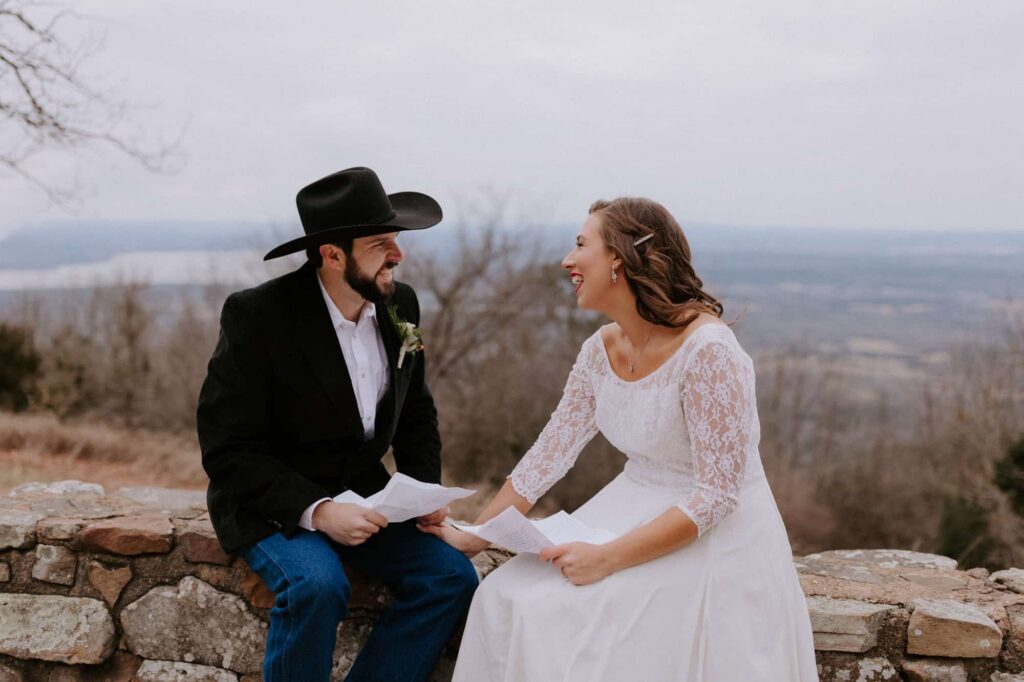 A bride and groom laugh while sharing their private vows to each other at Mt. Nebo State Park before their wedding on the mountain.
