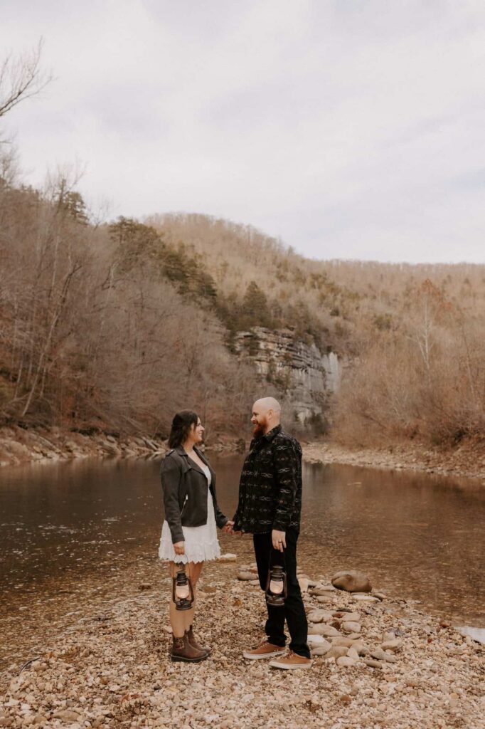 A couple poses for a photo at Steel Creek during their early winter elopement in Arkansas.